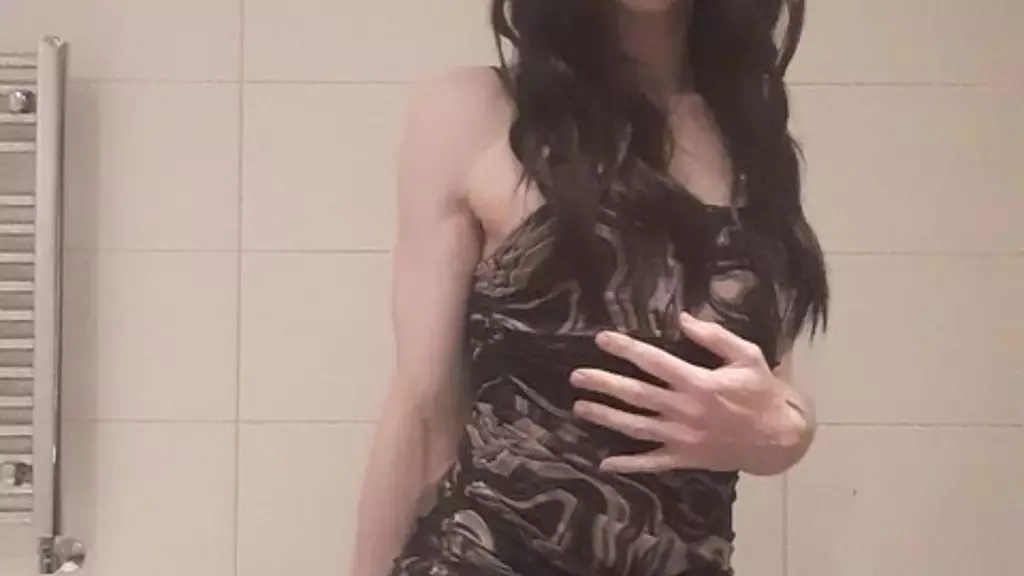 sexy femboy in tights and dress playing with dildo