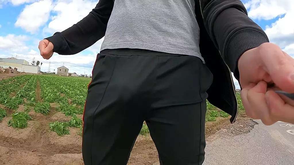 the wind impacts in the dick of a tracksuited sexy boy in slow motion (shiny clothes)
