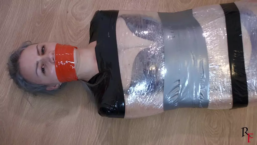 barefoot astrid is tightly wrapped with film and tape